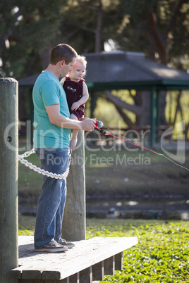 Cute Young Boy and Dad Fishing on the Lake Dock
