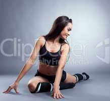 Image of pretty slim brunette doing stretching