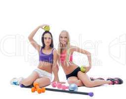 Lovely young athletes posing with sports equipment