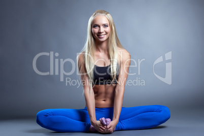 Merry muscular blonde posing in lotus posture