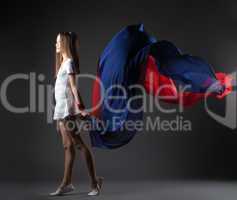 Graceful little athlete posing with colorful cloth