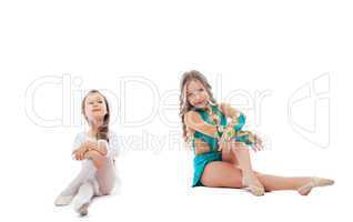 Two adorable young gymnasts posing in studio