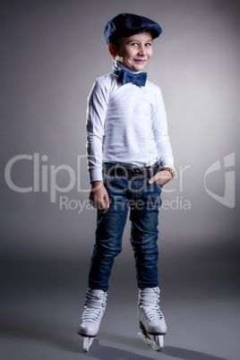 Smiling stylishly dressed boy posing in ice skates