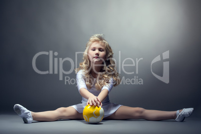 Fascinating little gymnast posing on split