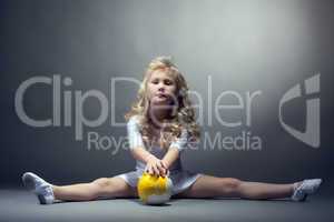 Fascinating little gymnast posing on split