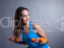 Merry young woman exercising with dumbbells