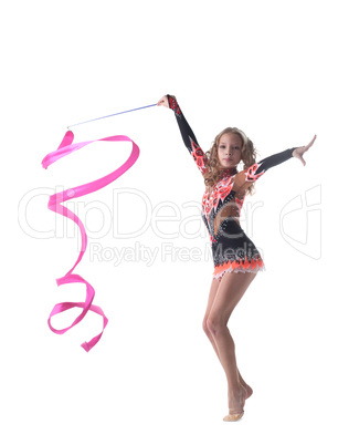 Graceful little gymnast dancing with ribbon