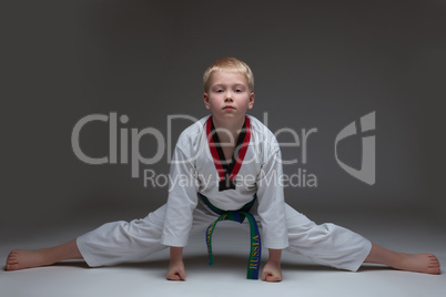 Studio shot of karate boy exercising