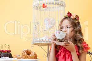 Portrait of elegant little lady drinking tea