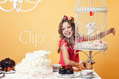 Merry girl posing with sweets in vintage interior