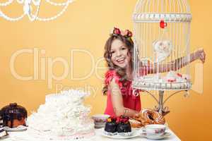 Merry girl posing with sweets in vintage interior