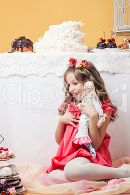 Surprised pretty girl posing with lots of sweets