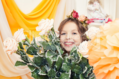 Happy little girl posing with big bouquet of roses