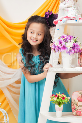 Portrait of adorable smiling girl in blue dress