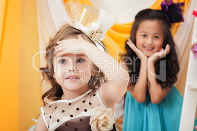 Portrait of cute girlfriends playing in studio