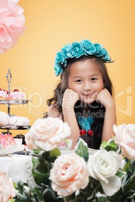 Dreamy little girl posing with flowers, close-up