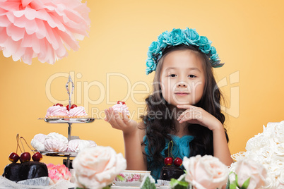 Lovely little girl posing while drinking tea