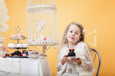 Charming little lady posing with cake