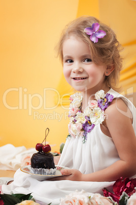 Pretty little girl posing with chocolate cake