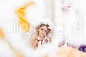 Cute little girl posing in flower wreath, close-up