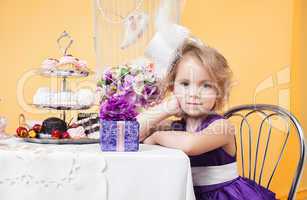 Beautiful little girl posing in feast with gift