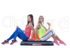 Pretty sporty girls posing with gymnastic items