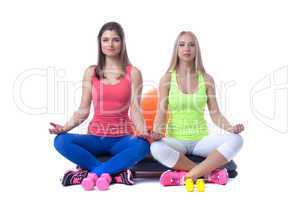 Young attractive female athletes posing in studio