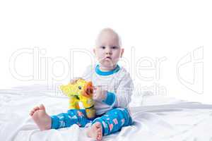 Cute little boy playing with toy in studio
