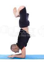 Image of calm man doing yoga handstand