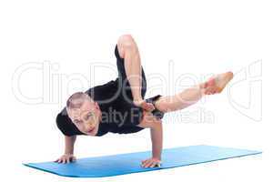 Flexible middle-aged yogi posing looking at camera