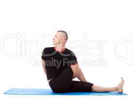 Side view of flexible man practicing yoga