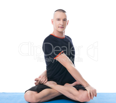Handsome middle-aged man posing in lotus position