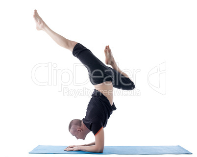 Flexible man posing in difficult yoga pose