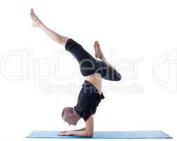 Flexible man posing in difficult yoga pose