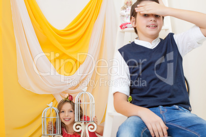 Cute brother and sister posing in vintage interior