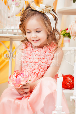 Adorable little girl posing with pink flower