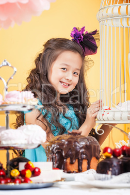 Little curly brunette posing with sweets