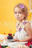 Portrait of slyly smiling girl posing with cake