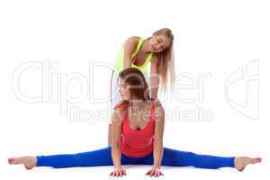 Young sporty girls doing stretching in studio