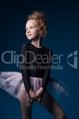 Graceful little dancer posing in studio