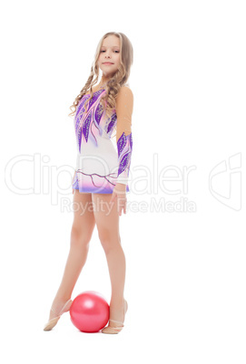Stately little artistic gymnast posing with ball