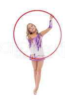Smiling artistic gymnast posing with red hoop