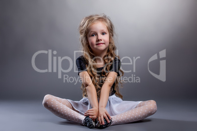 Cute little girl sitting in lotus position