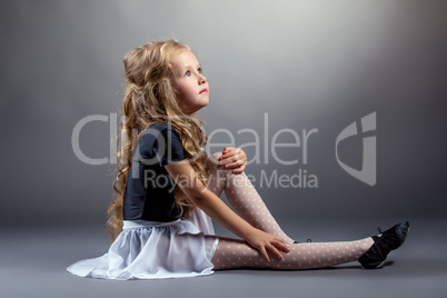 Image of curly blonde dancer sitting in studio