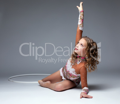 Graceful young gymnast dancing with hoop