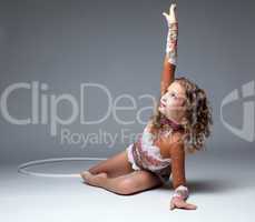Graceful young gymnast dancing with hoop