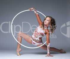 Image of elegant young gymnast dancing with hoop