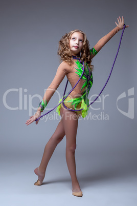 Focused on performance gymnast dancing with rope