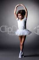 Graceful little gymnast performs in studio