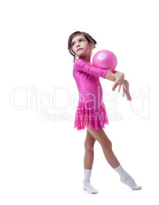 Thoughtful little gymnast performs with ball